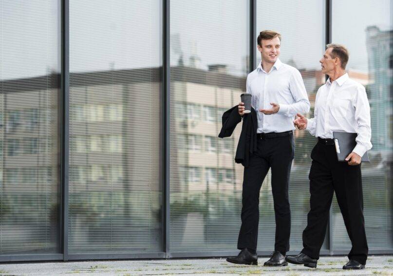 businessmen-having-conversation-while-walking-min